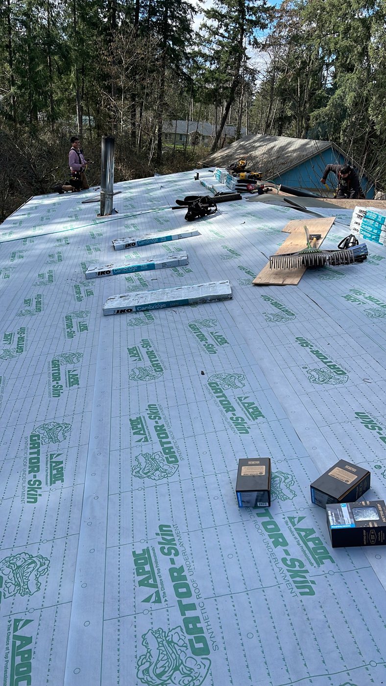 Mr. Roof crew re-decking and papering a roof mid-tear-off